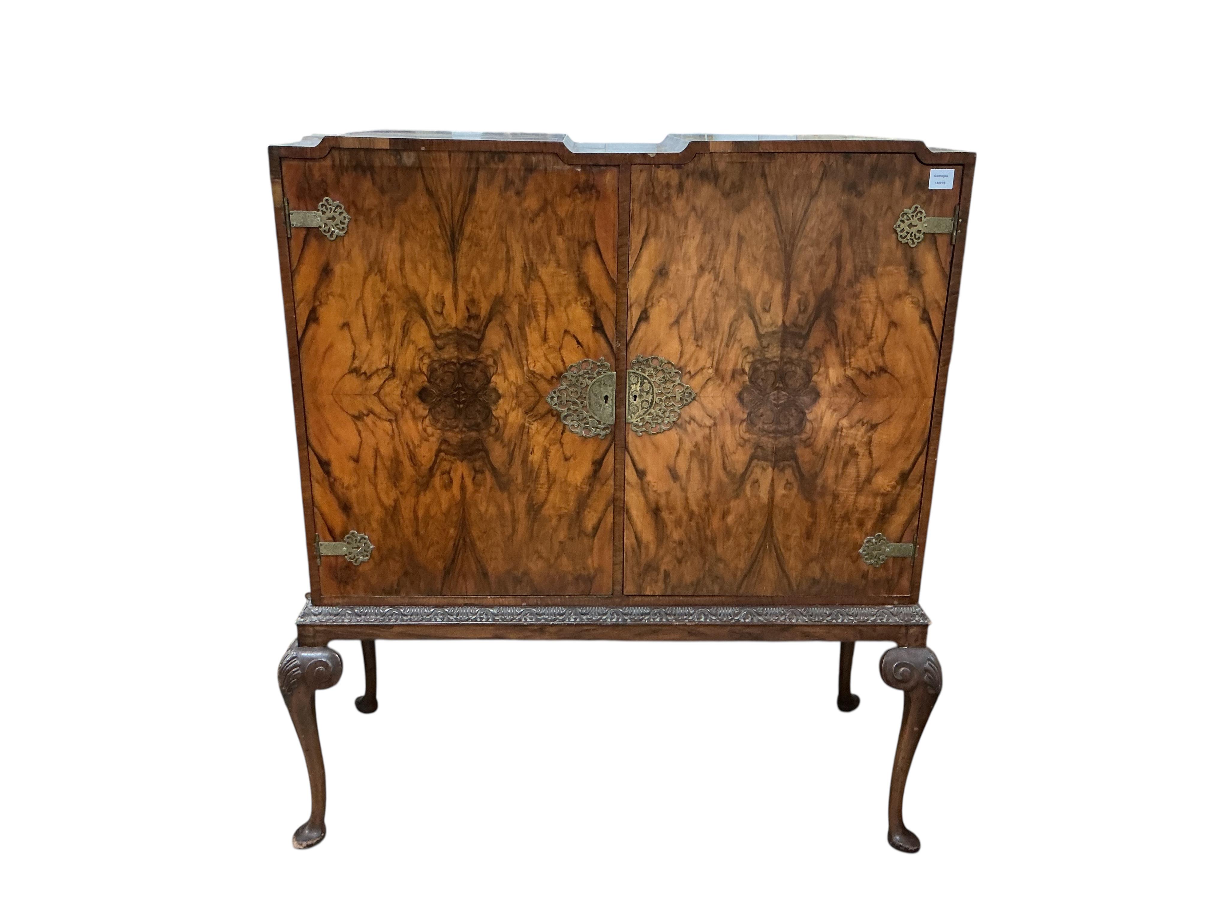 A Queen Anne Revival walnut side cabinet, width 128cm, depth 56cm, height 140cm